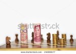 stock-photo-chinese-yuan-stand-on-chess-board-as-king-246088177